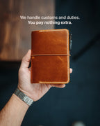 The Adventurer | Gloss held in hand with a pen clipped to the elastic