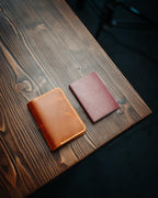 The Adventurer | Gloss next to a passport for size comparison